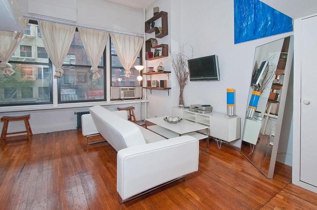 纽约公园大道公寓城毗邻时代广场的客厅配有白色的沙发和桌子