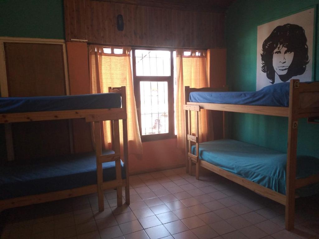 埃博森Hostel "La Casita Naranja"的客房设有两张双层床和一扇窗户。