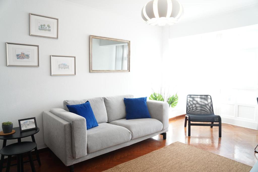 拉科鲁尼亚Amazing Location CORUÑA DOWNTOWN的客厅配有带蓝色枕头的沙发