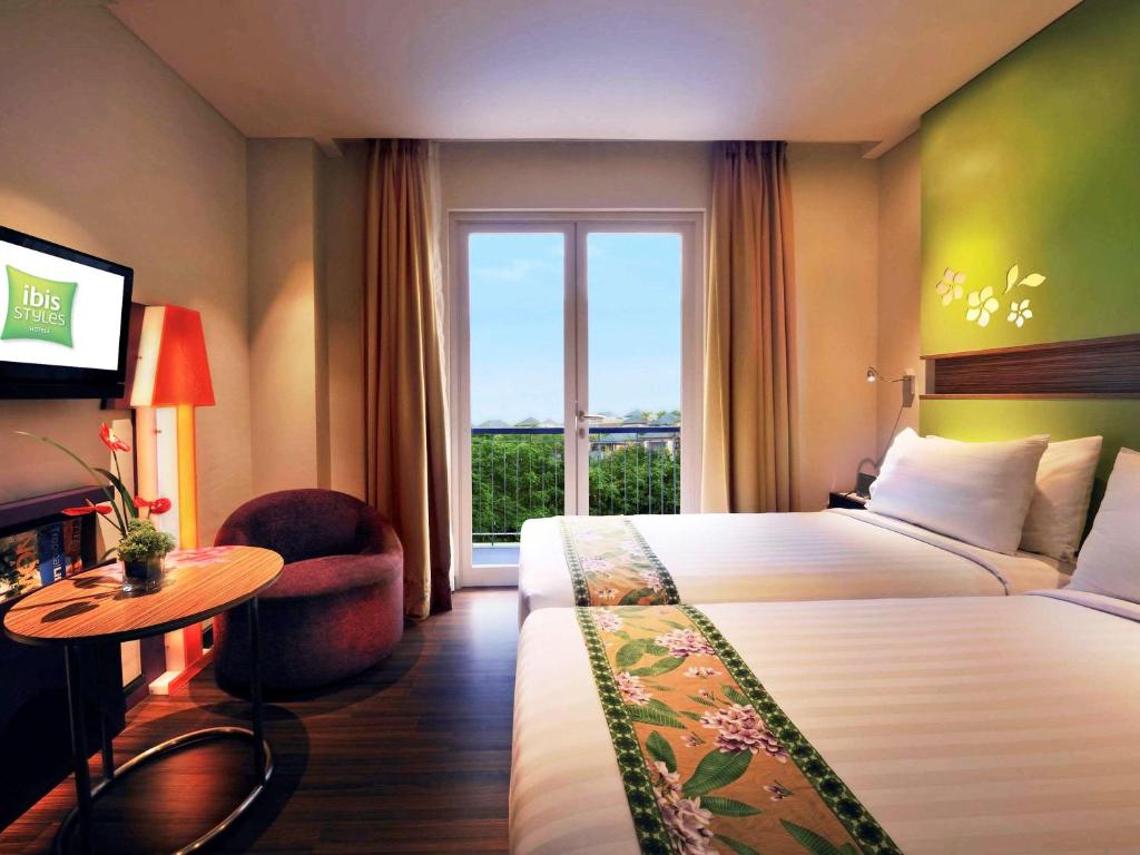 登巴萨巴厘岛登巴萨宜必思尚品酒店的一间设有大床和窗户的酒店客房