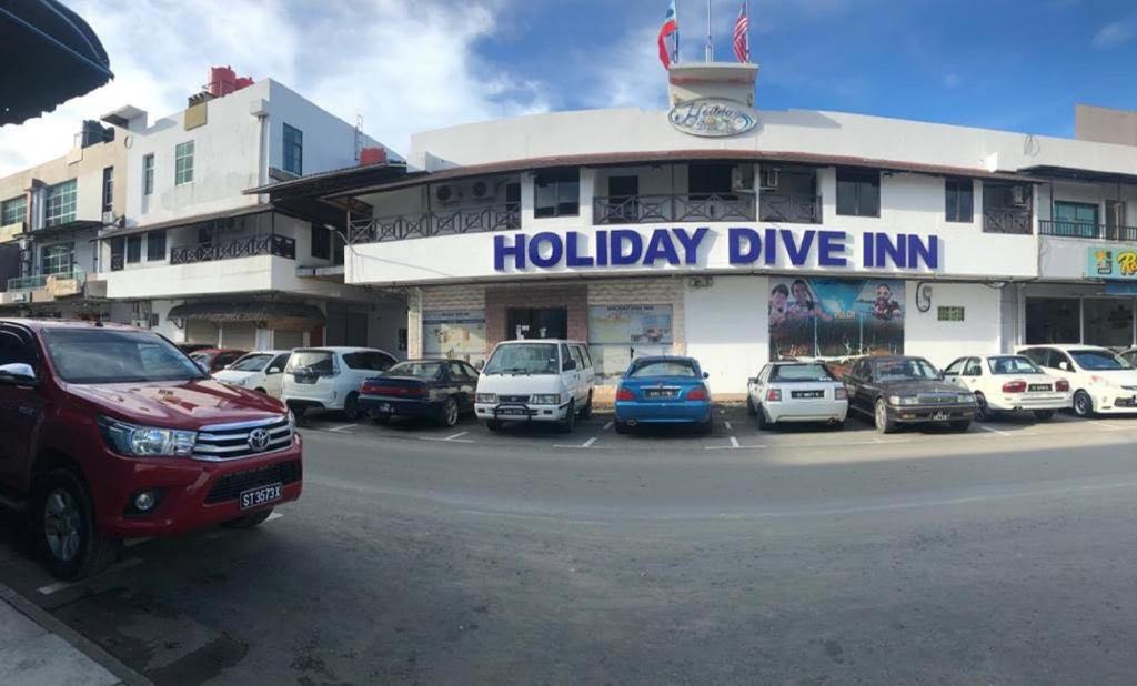仙本那Holiday Dive Inn的假日车道旅馆前的停车场