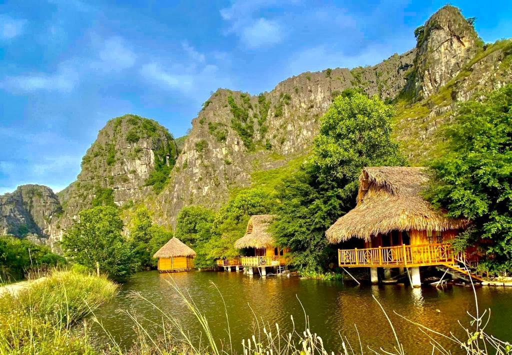 宁平Hang Lan Bungalow的水面上的村庄,以山为背景