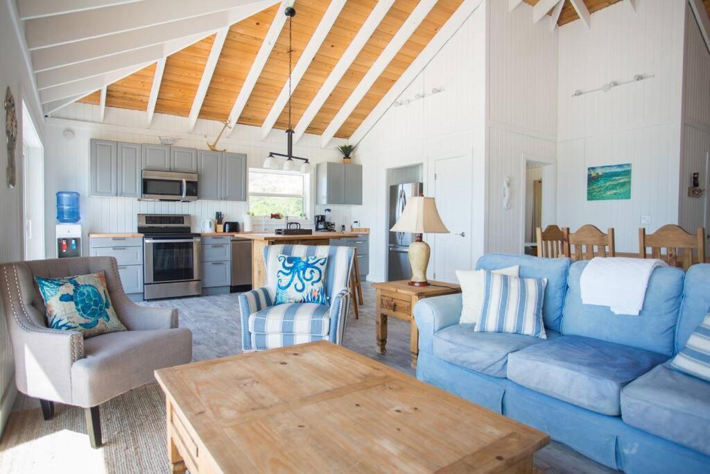 Forbes HillSunset Cove的客厅配有蓝色的沙发和桌子