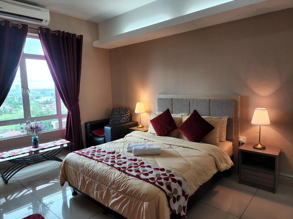 哥打巴鲁The Viana Apartment 1的一间卧室配有一张带红色枕头的大床