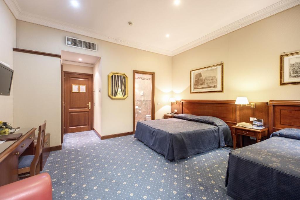 罗马阿托黎斯酒店的酒店客房设有两张床和电视。