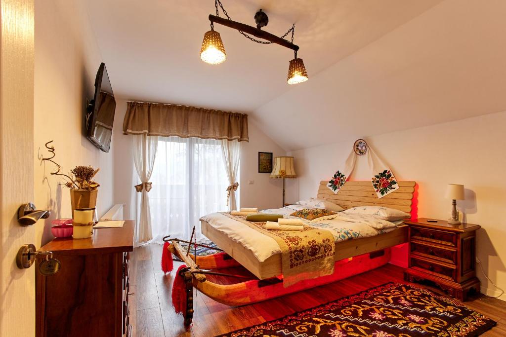 上维谢乌Gradina Lu' Ion "A Home Away From Home"的一间卧室设有一张大床和一个窗户。