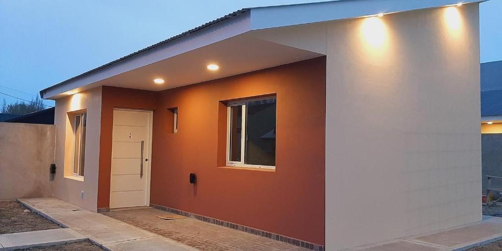 埃尔卡拉法特Apart HAMU的一座带橙色墙壁和白色门的小房子