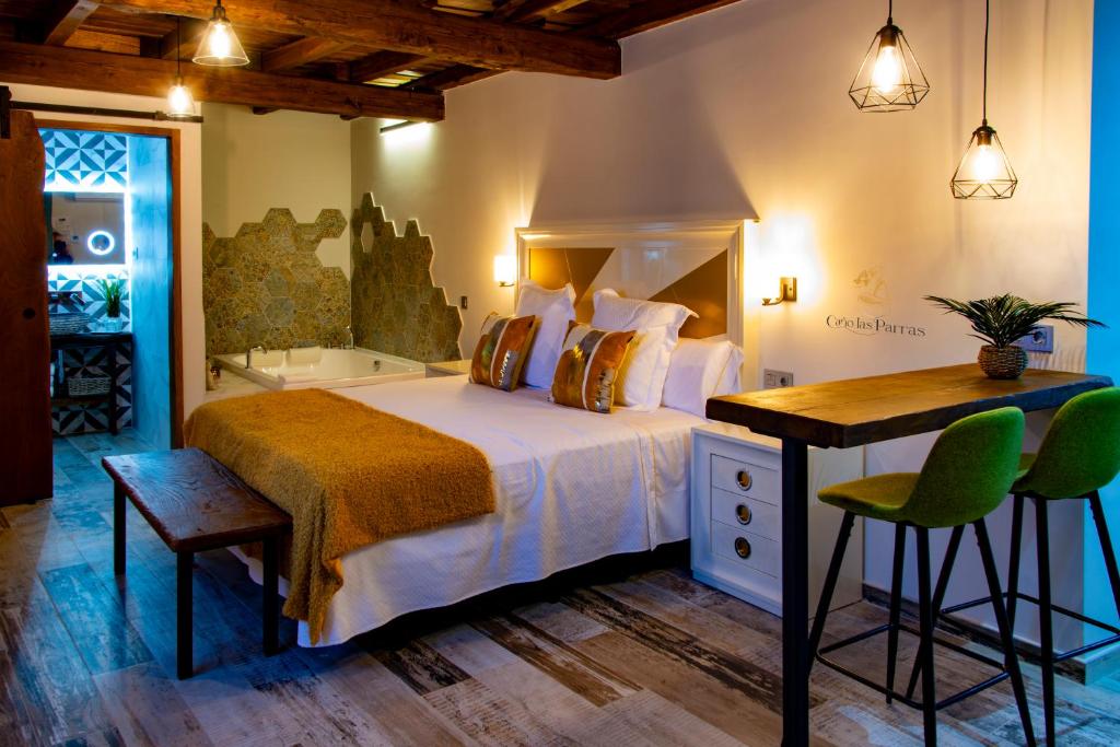 埃尔瓦Apartamentos Caño las Parras的一间卧室配有一张床、一张书桌和一个浴缸