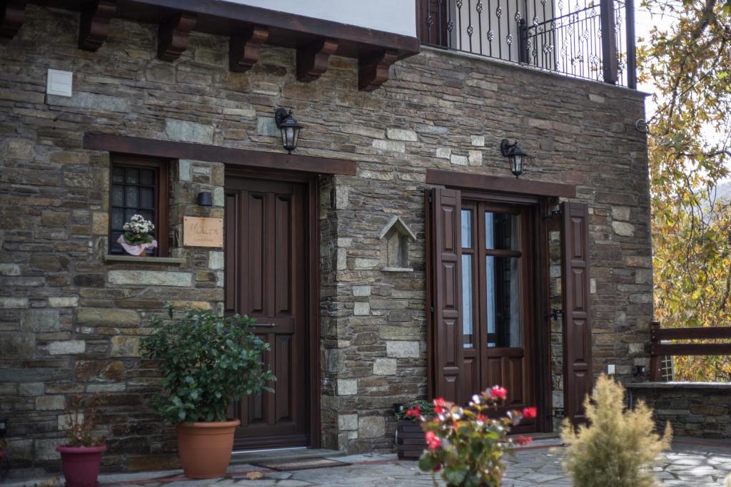 扎戈拉Μελίτη Pelion Luxury Living的砖砌建筑,设有两扇门和阳台