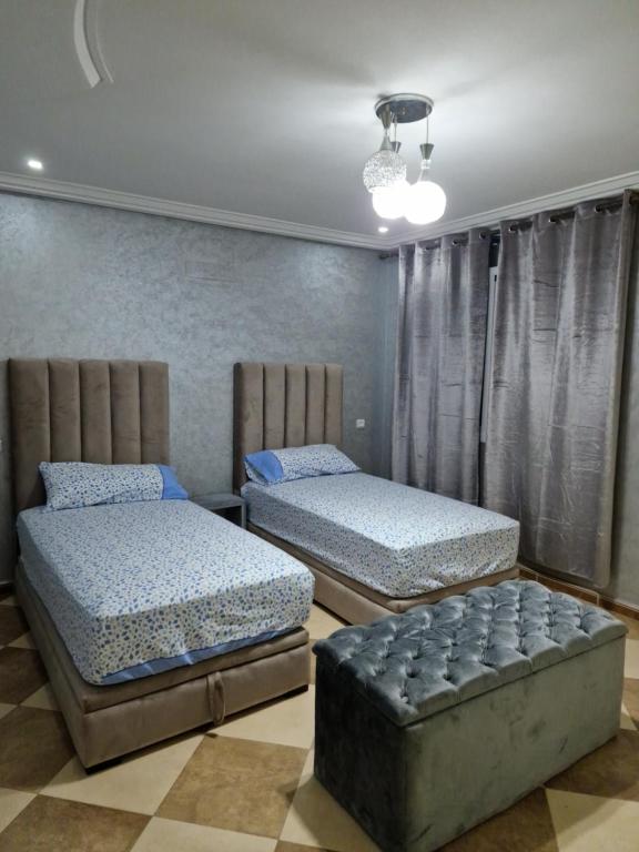 纳祖尔RESIDENCE LA CORNICH的一间卧室配有两张床和一张沙发。