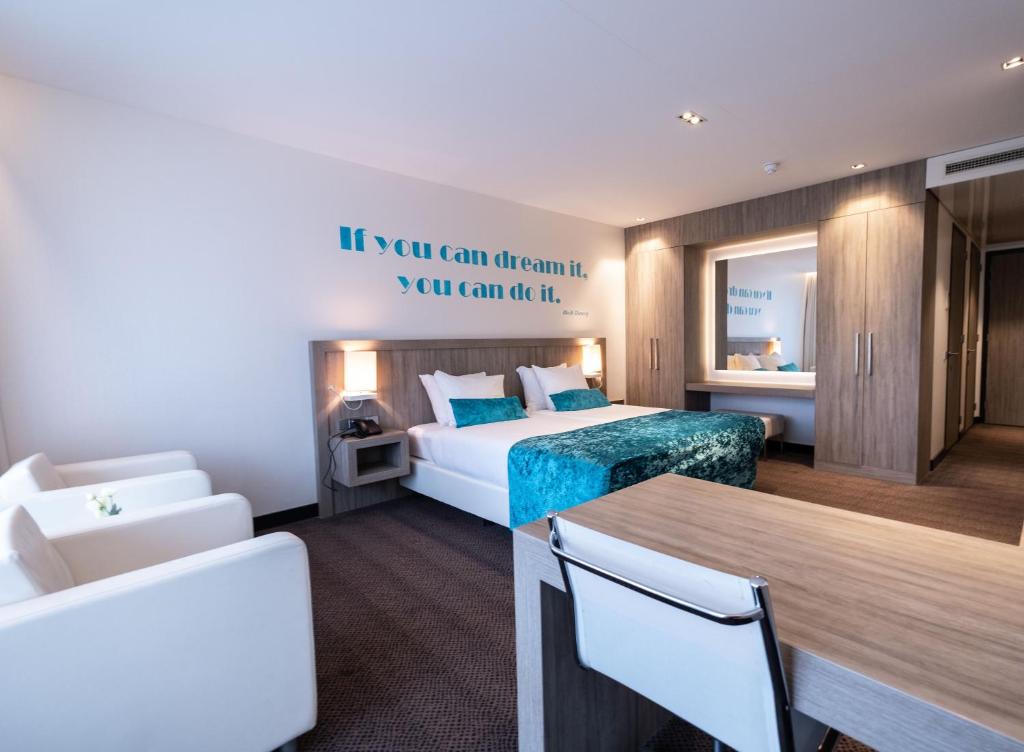 菲亚嫩Van der Valk Hotel Vianen - Utrecht的酒店客房带一张床、一张桌子和椅子