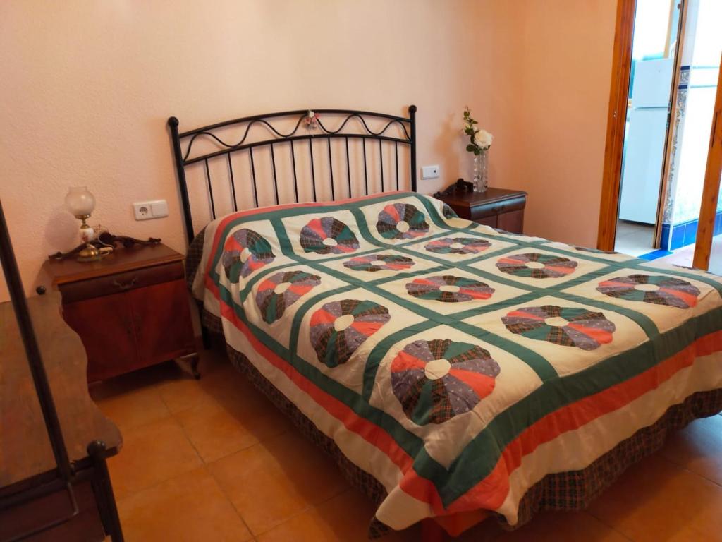 贝尼多姆Apartamentos Casa May II - Centro Benidorm的一间卧室配有一张带五颜六色被子的床