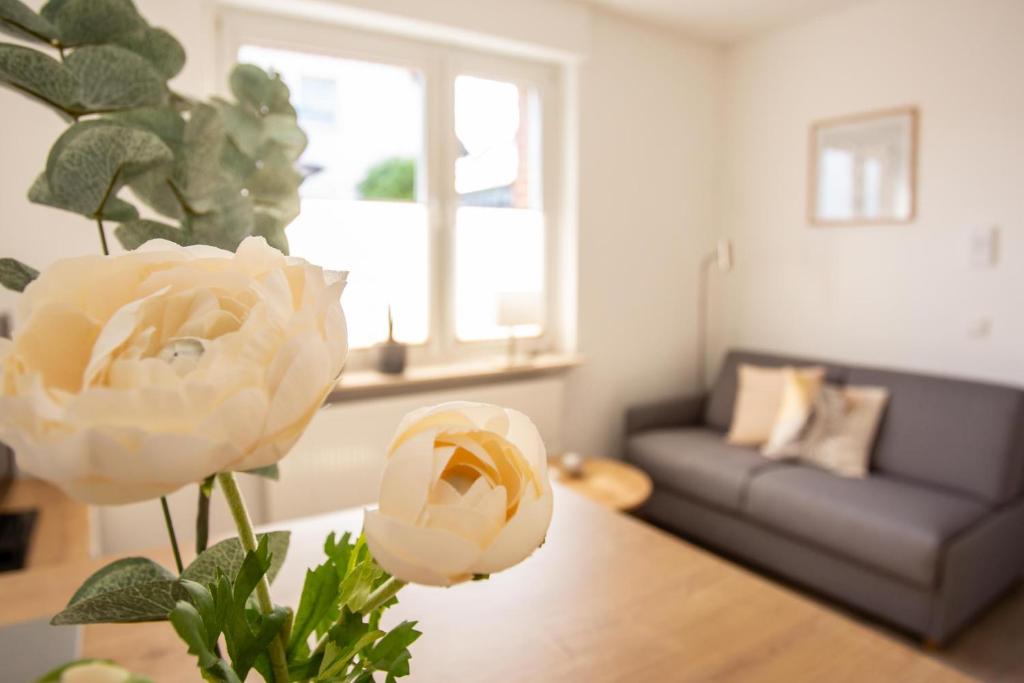 格奥尔格斯马林许特boardinghouse44的客厅配有沙发和桌子上的花朵