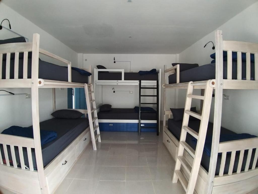 NangalimaAnjo Maumere Hotel & Restaurant的宿舍间设有三张双层床。
