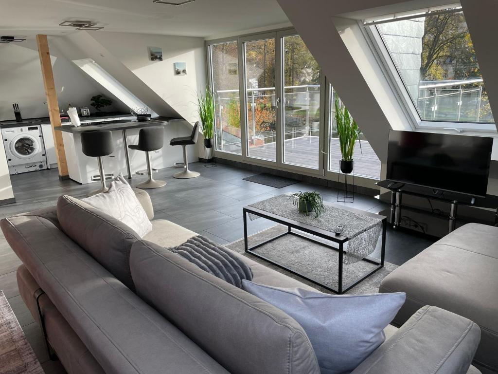 巴特诺因阿尔-阿尔韦勒Exklusive Wohnung mit Ahrblick 1 und Dachterrasse的客厅配有沙发和桌子