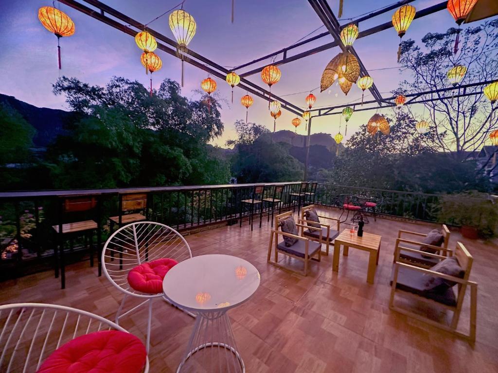 宁平Trang An Moon Garden Homestay的天井配有桌椅和中式灯。