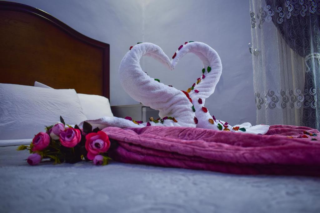 开罗Crown Hotel的心形的带毛巾的床