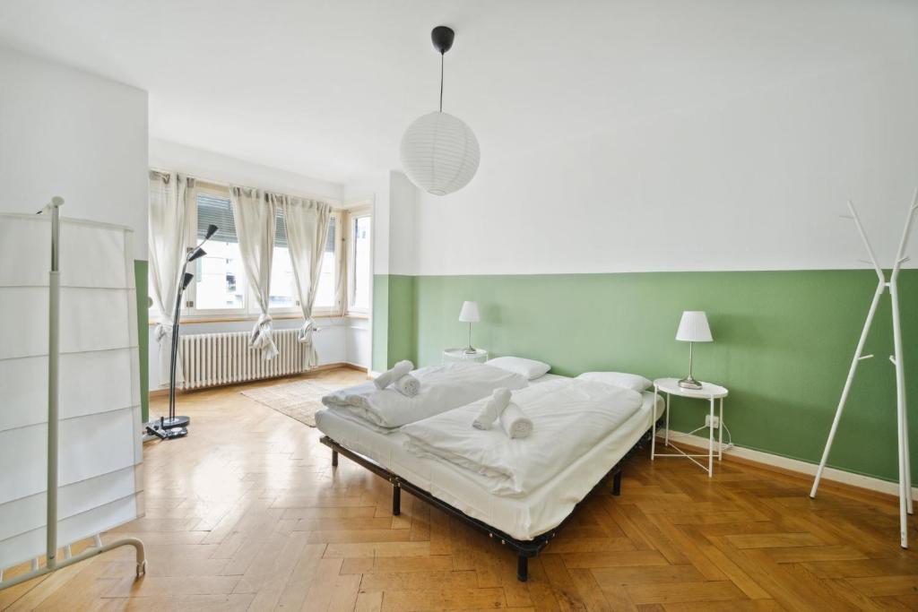 苏黎世Central Apartment for City Explorers 222的一间卧室设有一张床和绿色的墙壁