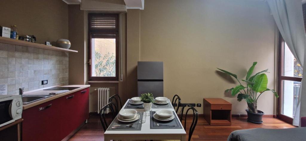米兰MilanRentals - Vigliani Apartments的厨房配有带餐具的桌子