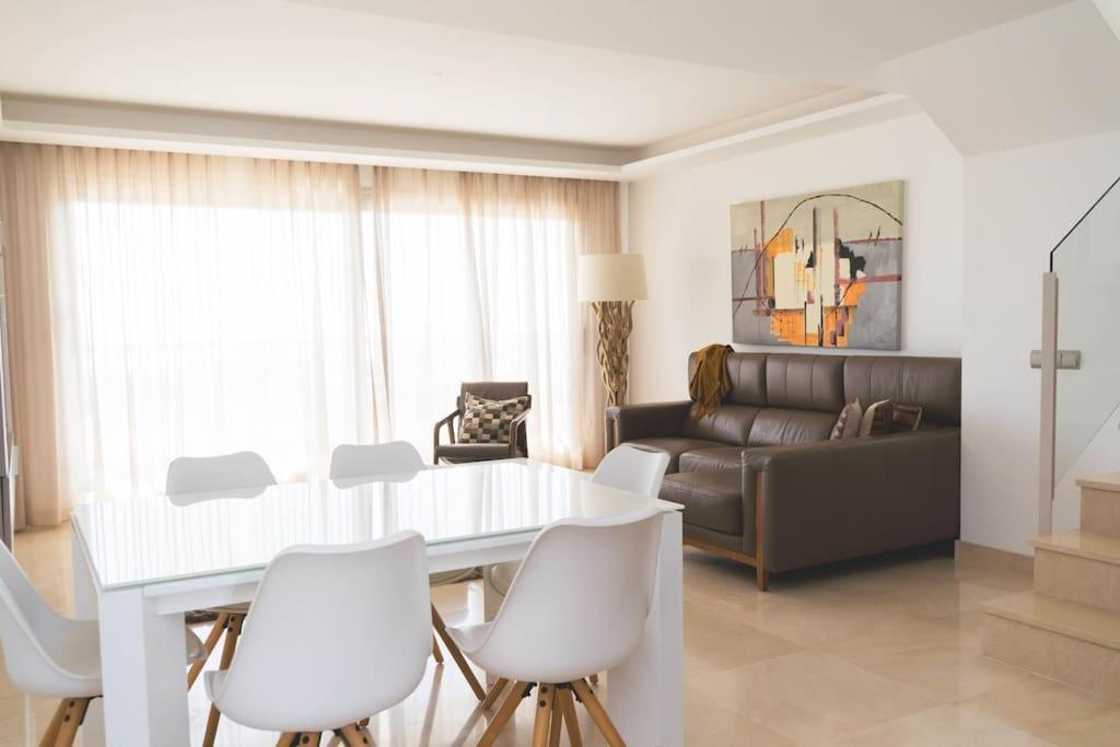 卡拉德米哈斯Exclusivo Atico en La Cala Golf的客厅配有白色的桌子和白色的椅子