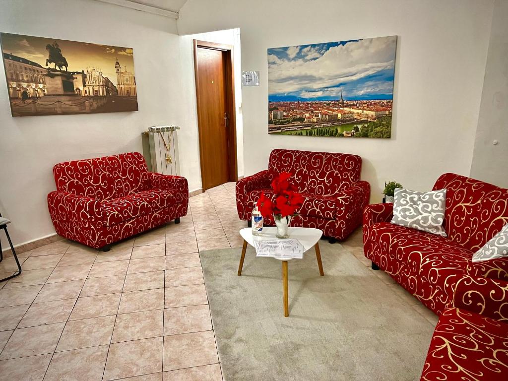 都灵B&B Da Lisa的客厅配有两张红色的沙发和一张桌子