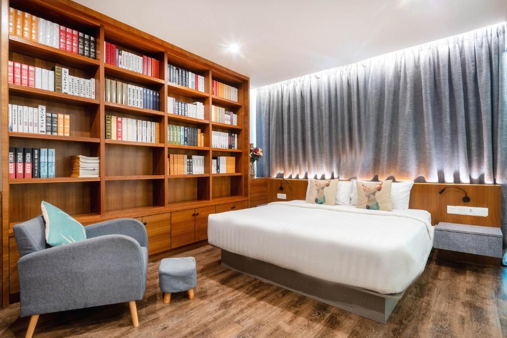 乔治市Apple Hotel Times Square的一间卧室设有一张床和一个书架