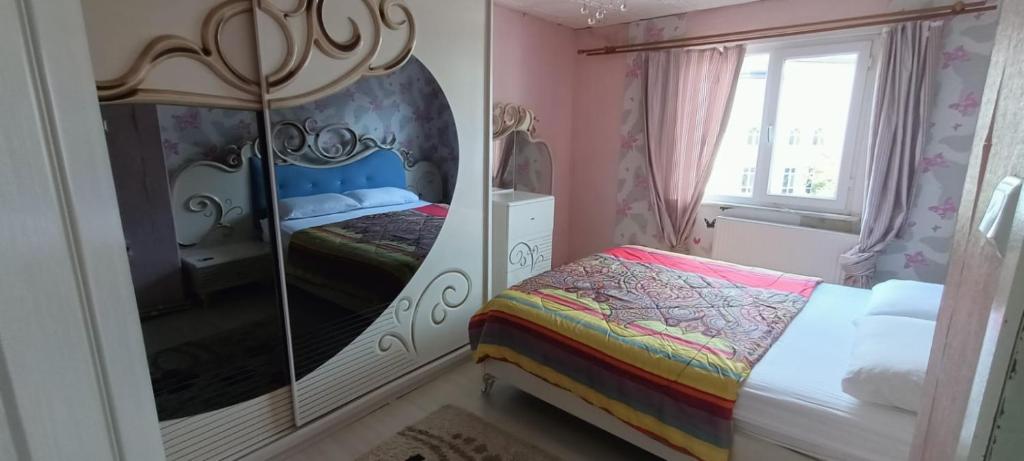 亚洛瓦ALTAY MOTEL的一间卧室配有一张床和一面大镜子