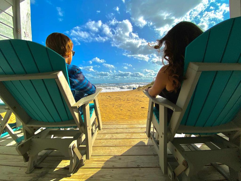 斩魔山约翰·扬西海滨酒店的坐在沙滩椅上的男孩和女孩