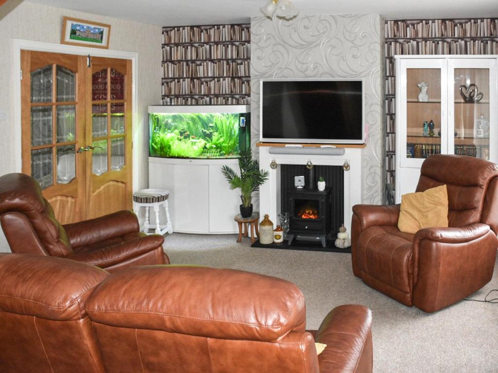 BareCoastal Retreat - Uk37827的客厅配有皮革家具和平面电视