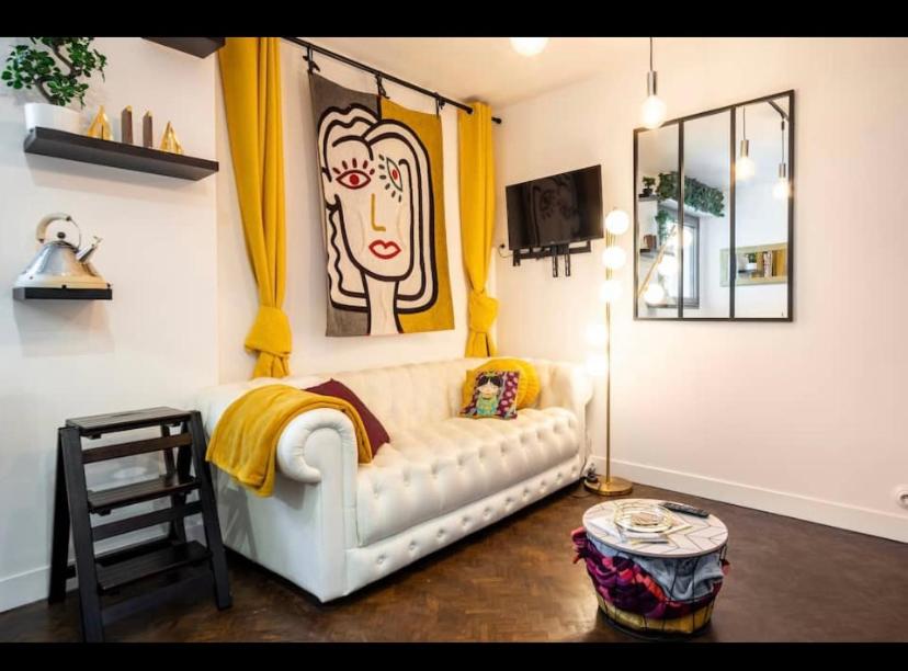 多维尔Appartement Coeur de Deauville charme absolu的客厅配有白色沙发和绘画作品