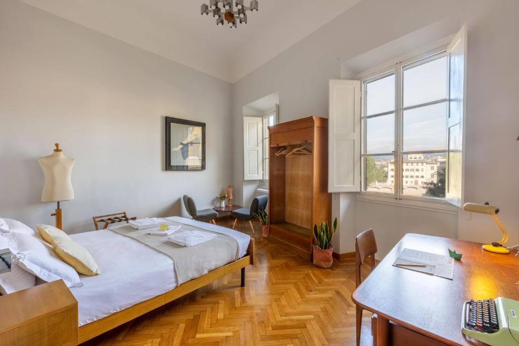 佛罗伦萨夫沃阿诺住宿加早餐旅馆的一间卧室配有一张床、一张桌子和一张桌子