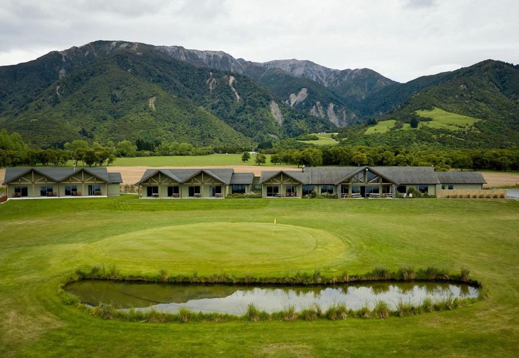 凯库拉Koura Bay Golf Resort的享有以山脉为背景的高尔夫球场的景致