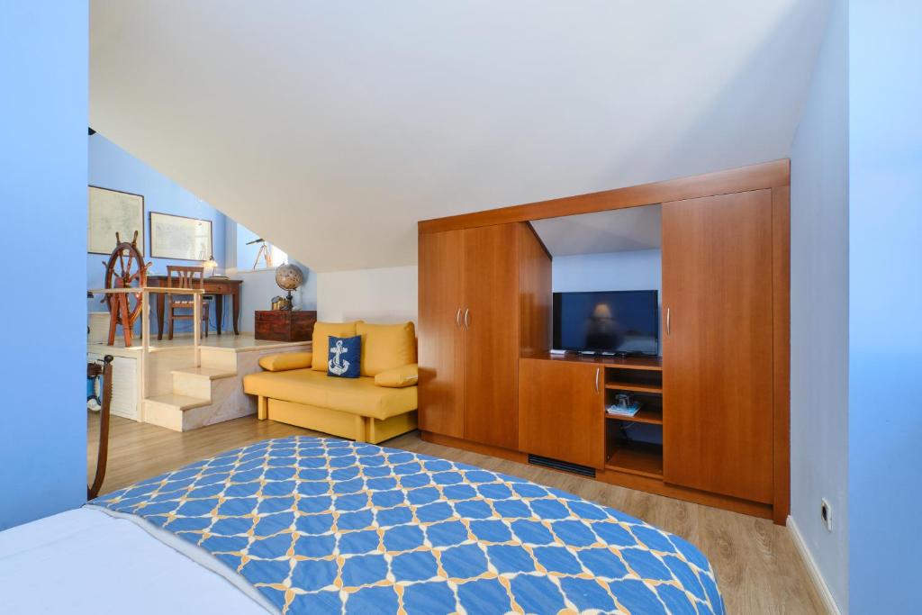 木洛希尼梅尔梅尔套房酒店的一间卧室配有一张床和一台电视