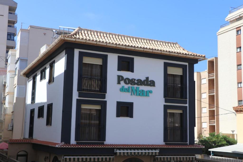 洛斯马蒂雷斯201 I Posada del Mar I Encantador hostel en la playa de Gandia的建筑的侧面有标志