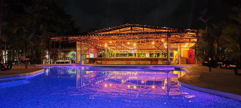 福尔图纳阿雷纳背包客度假村旅馆的游泳池,在晚上设有酒吧