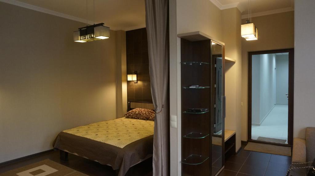 基希讷乌迈恩丝锥特公寓的一间小卧室,配有一张床和镜子