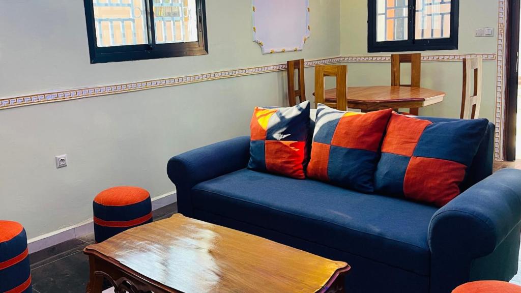 BafoussamCharmante maison cozy et conviviale的客厅配有蓝色的沙发和木桌