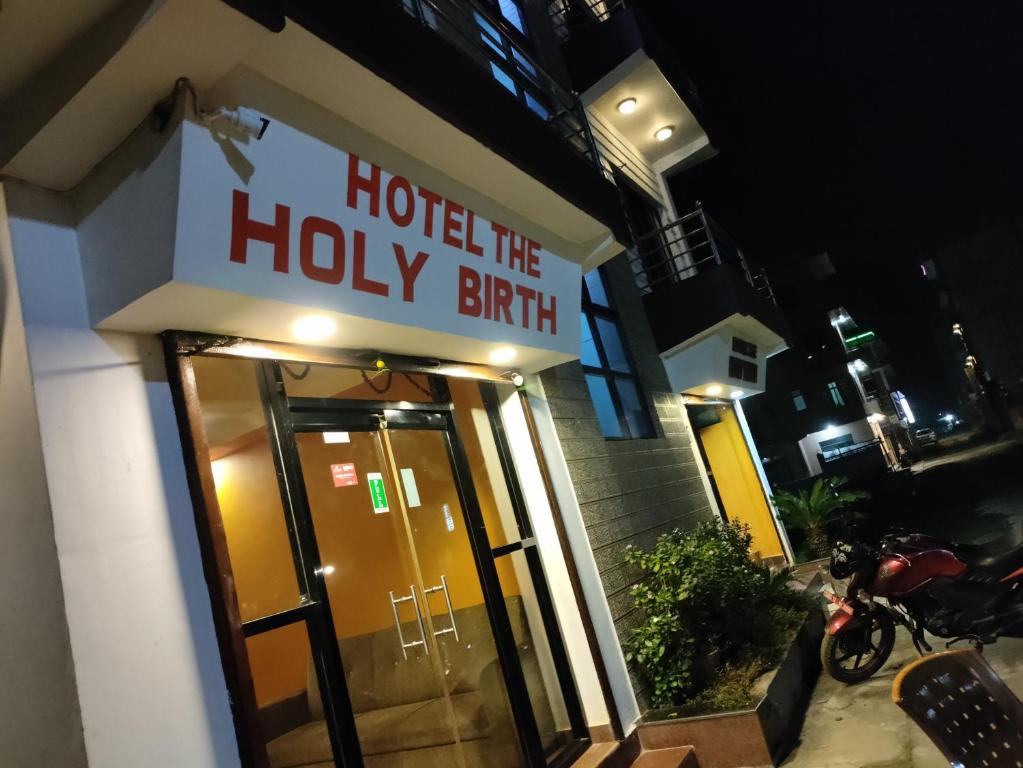 拉明德Hotel The Holy Birth的带有圣诞生的标志的酒店入口