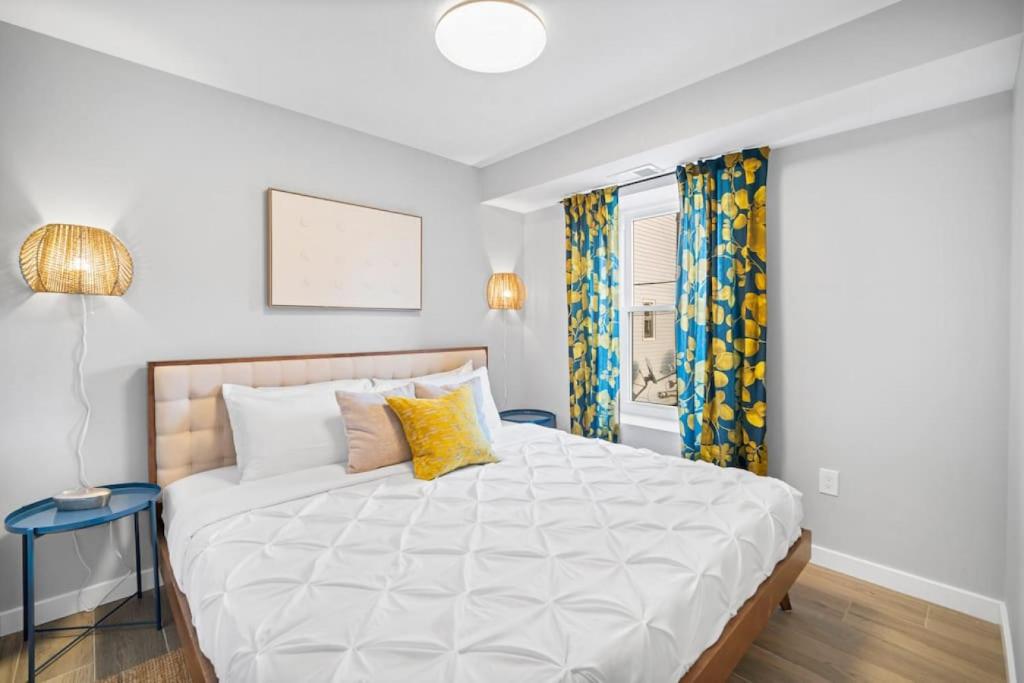 大西洋城Unit 2 Closest home to Stockton College European style的卧室配有一张带黄色枕头的大型白色床。