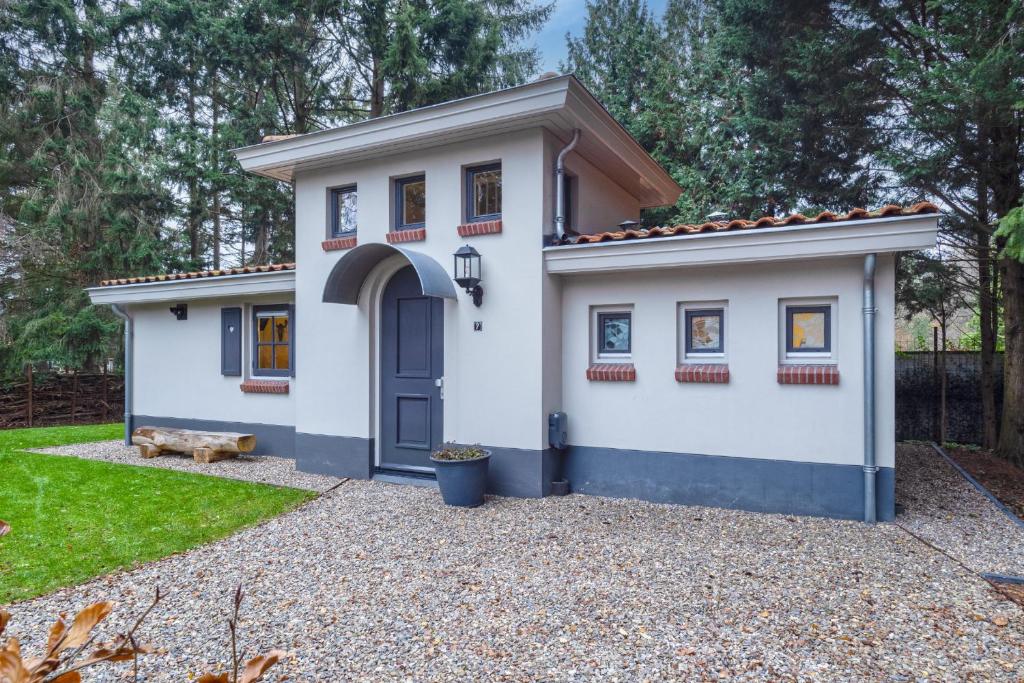 埃尔默洛Boshof 7的一间白色的小房子,设有蓝色的门
