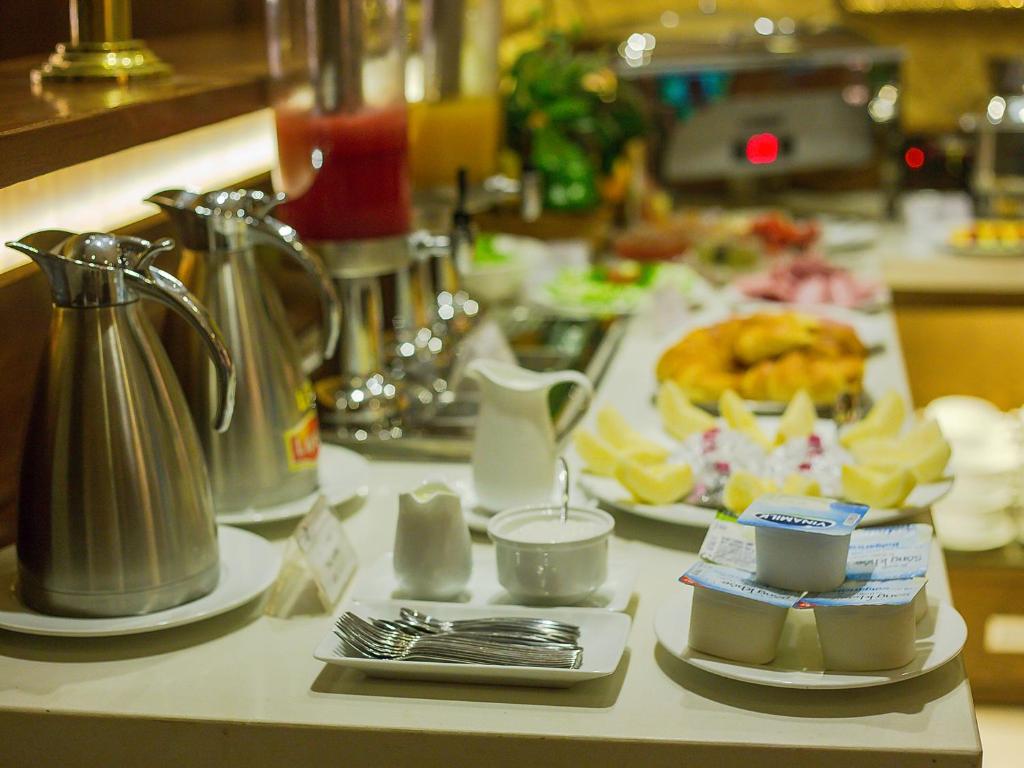 河内Emerald Boutique Hotel的厨房柜台配有餐桌和食物