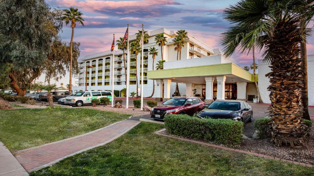 梅萨Holiday Inn & Suites Phoenix-Mesa-Chandler, an IHG Hotel的门前有车辆停放的酒店