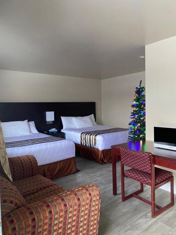哈里伯顿Silver Maple Motel的酒店客房,设有两张床和一棵圣诞树