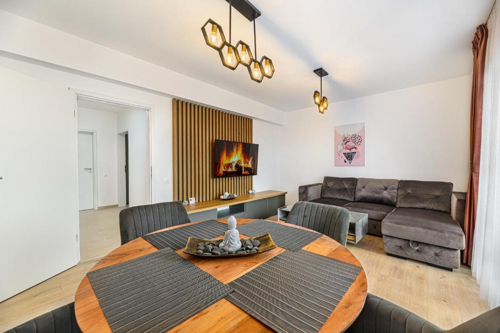 布拉索夫Luxury Landing Apartments Complex Qualis Brasov的客厅配有桌子和沙发