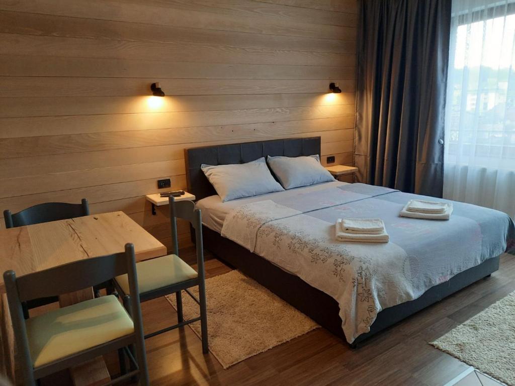 科拉欣穆尔德加公寓的一间卧室配有一张床、一张桌子和一张书桌