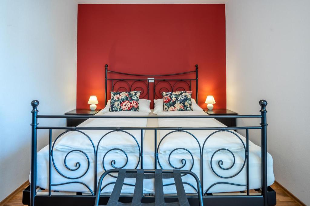 克拉尼斯卡戈拉T E M P F E R 2 Apartments & Rooms with new WELLNESS的一间卧室配有一张红色墙壁的床