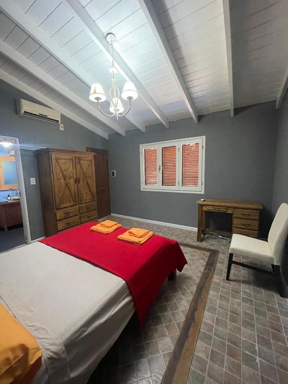 卡尔韦Casitas El Lago的一间卧室配有一张带红色毯子的大床