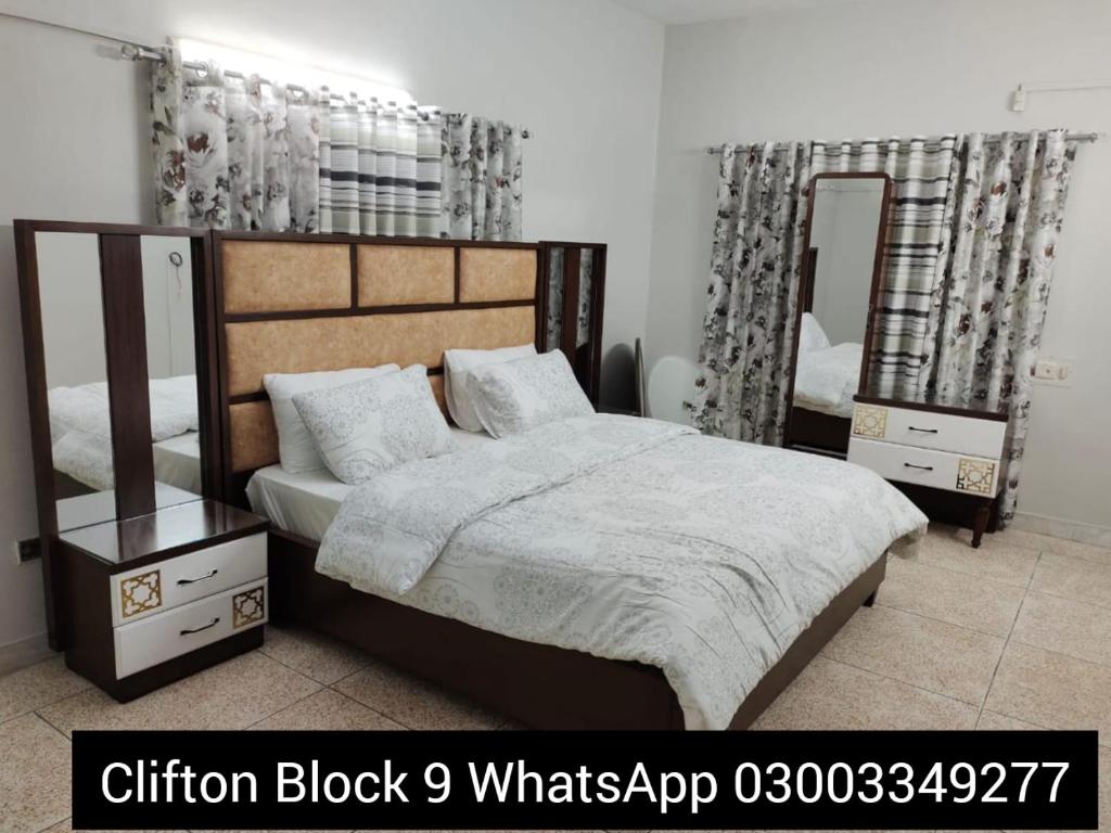 卡拉奇Karachi Guest House & Couple Hotel的一间卧室配有一张大床和两面镜子