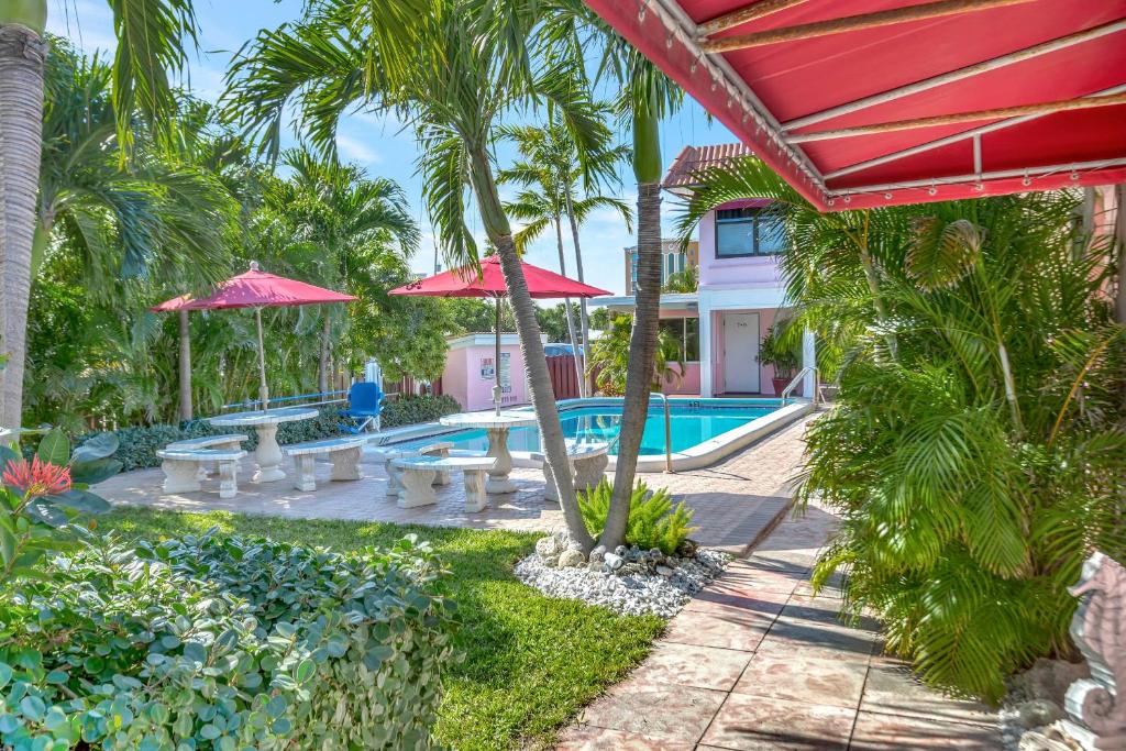 帕诺滩Seahorse Guesthouse的一个带游泳池和棕榈树的度假村