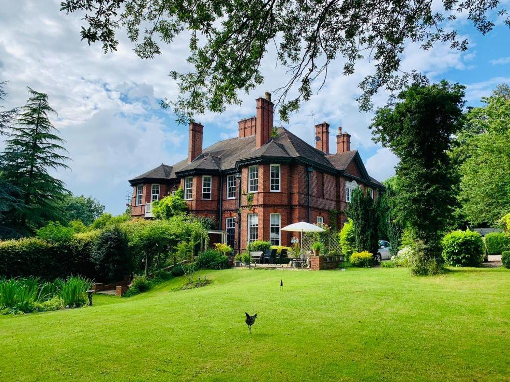 庞特佛雷特Hillthorpe Manor by Maison Parfaite - Large Country House with Hot Tub的一座带绿色草坪的大型砖屋